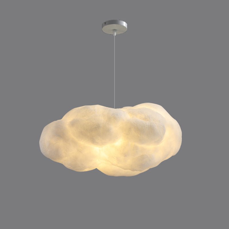 This Clérachic cloud-shaped pendant hangs lit against a plain grey backdrop, its canopy visible.