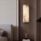 Alabaster wall light mounted in a minimalist hallway