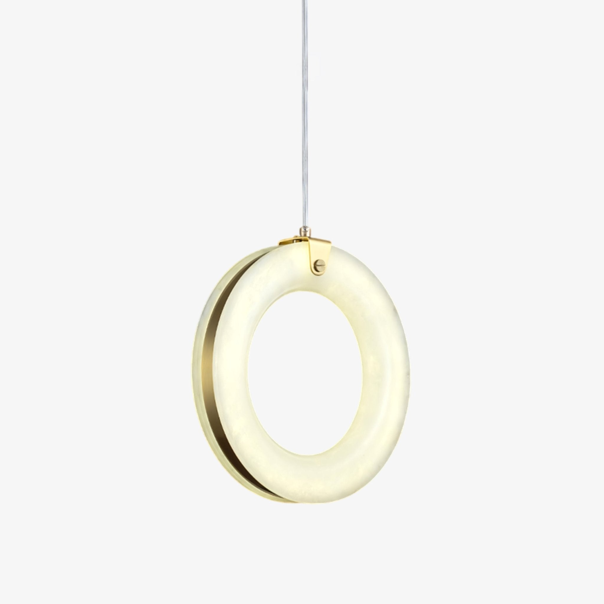 Alabaster ring pendant light lit warm, gold clamp and brass back ring, hanging on a clear cable