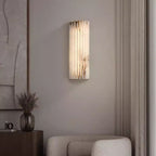 Alabaster wall light glowing in a warm neutral interior