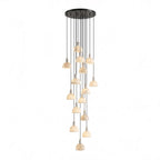 Many alabaster domes cascade from one round black ceiling plate at staggered heights, forming a tall unlit cluster of this Clérachic pendant.
