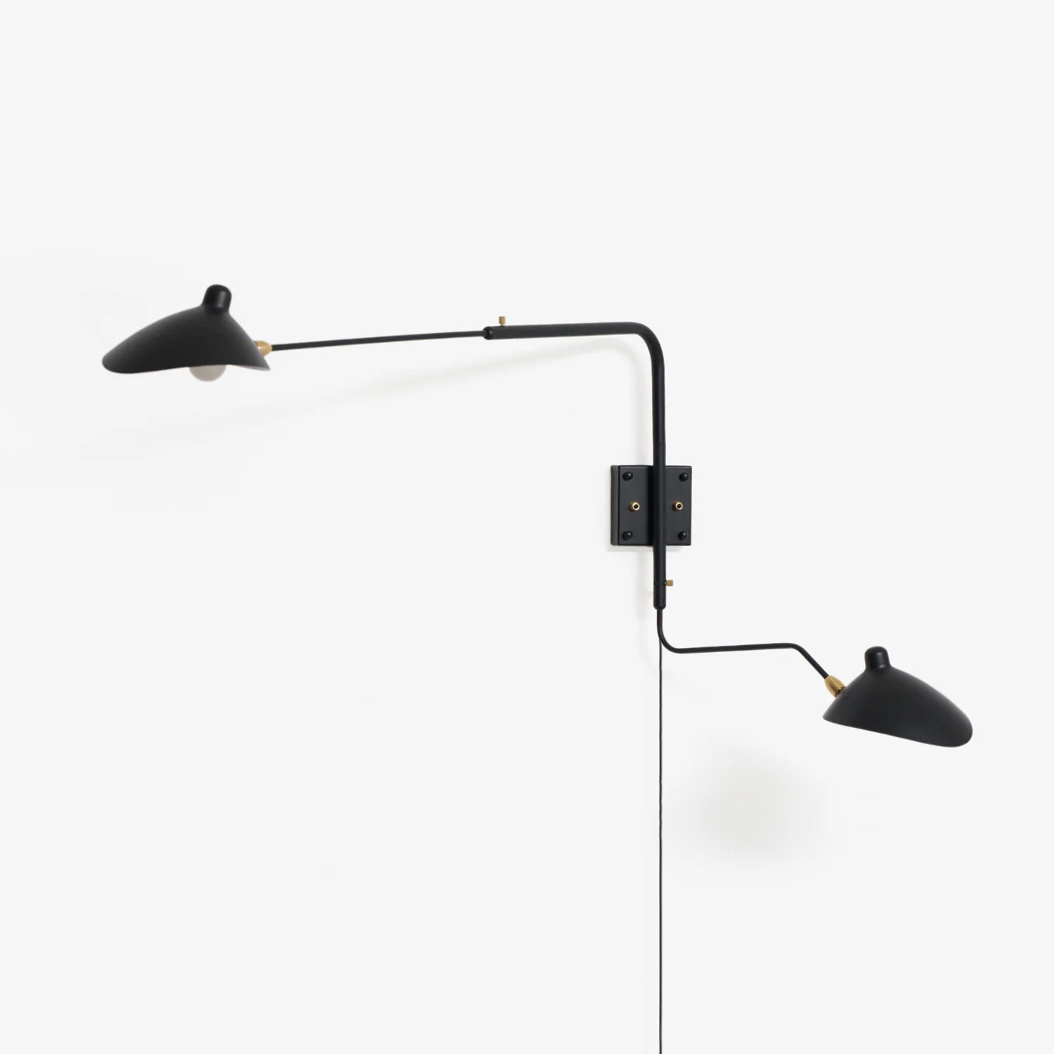 Wall sconce arm and shade detail against a pale interior wall