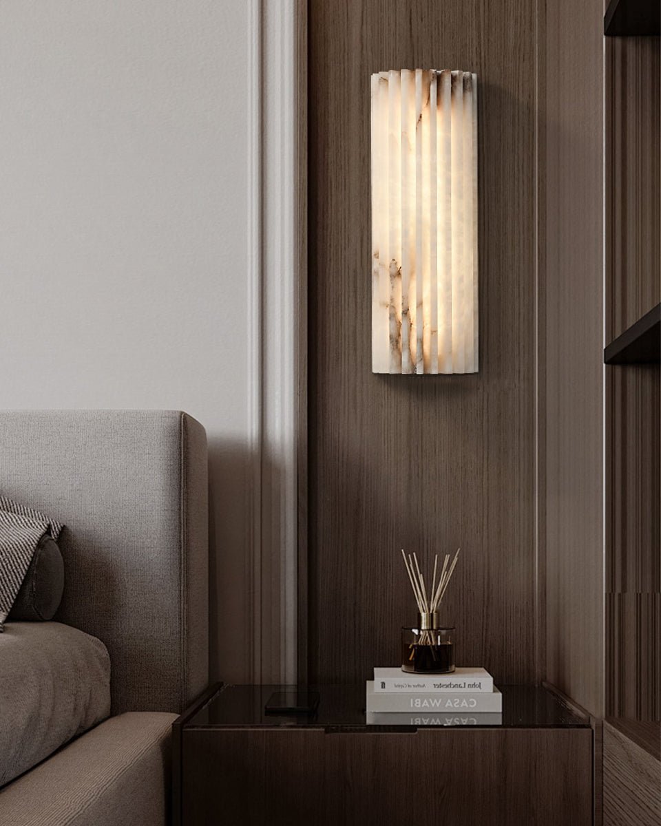 Alabaster wall light with gentle glow in a dim room