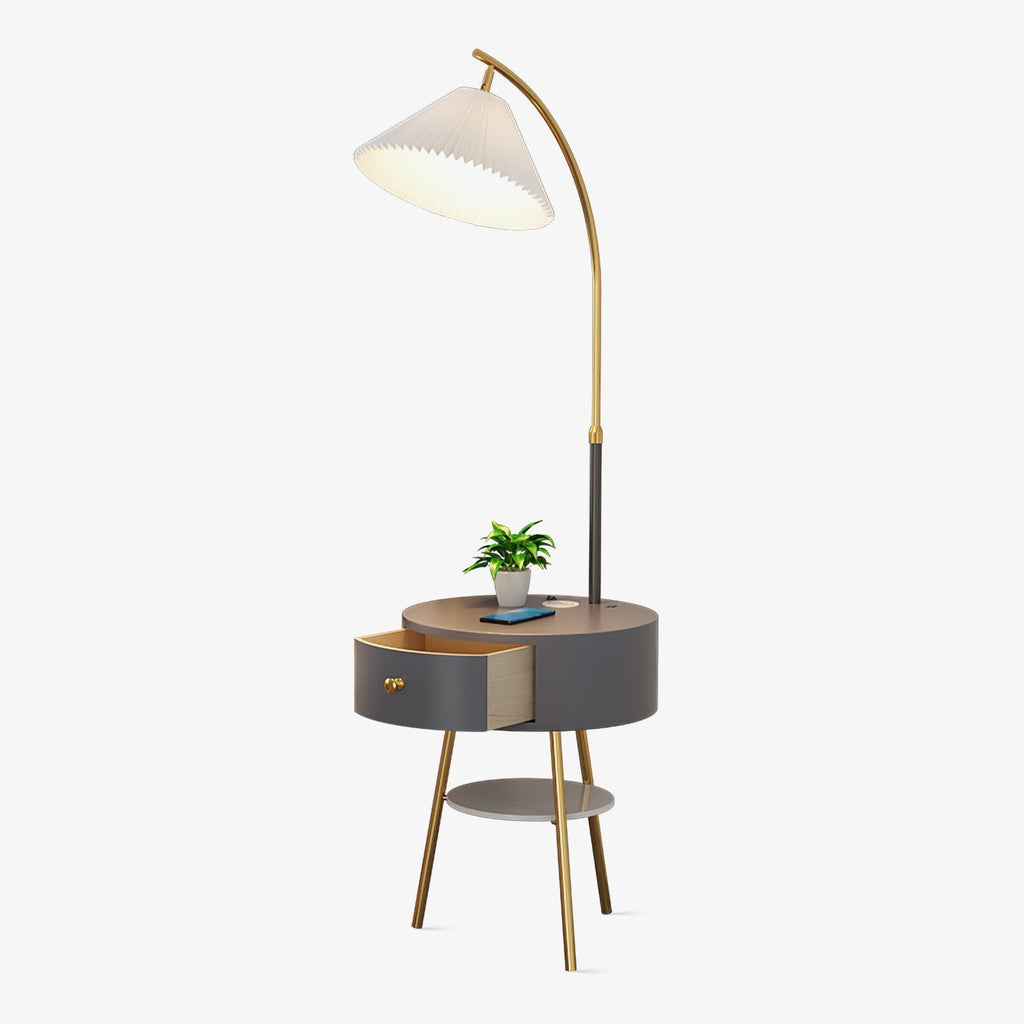 Clérachic pleated-shade arc floor lamp with its round charcoal side table, drawer closed, shown alone on a plain backdrop.