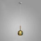 Glass globe pendant light shown lit in a reading corner