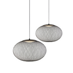 Black mesh pendant light hanging against a plain wall