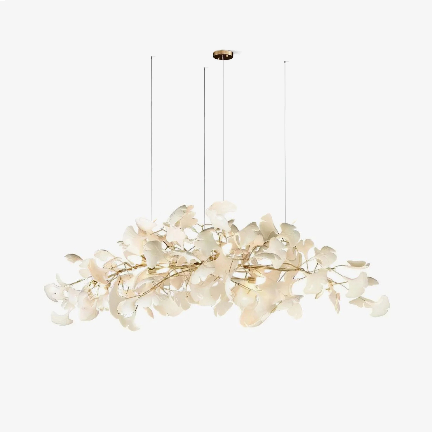 Horizontal leaf chandelier glowing over a dining setting