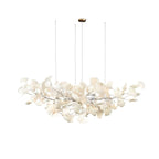Gingko leaf chandelier glowing warmly in a styled living room