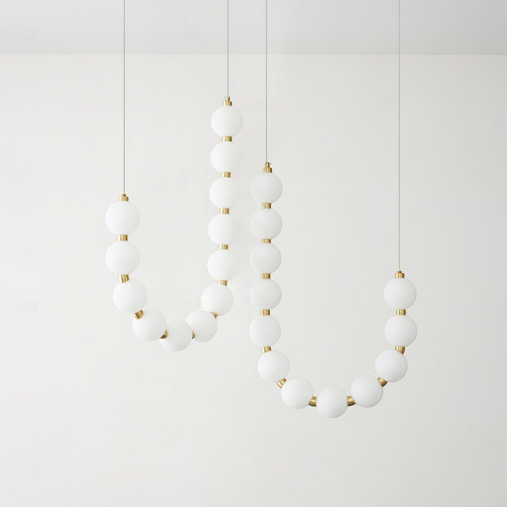 Acrylic pearl chandelier with clustered white orbs and warm light
