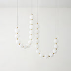 Acrylic pearl chandelier with clustered white orbs and warm light