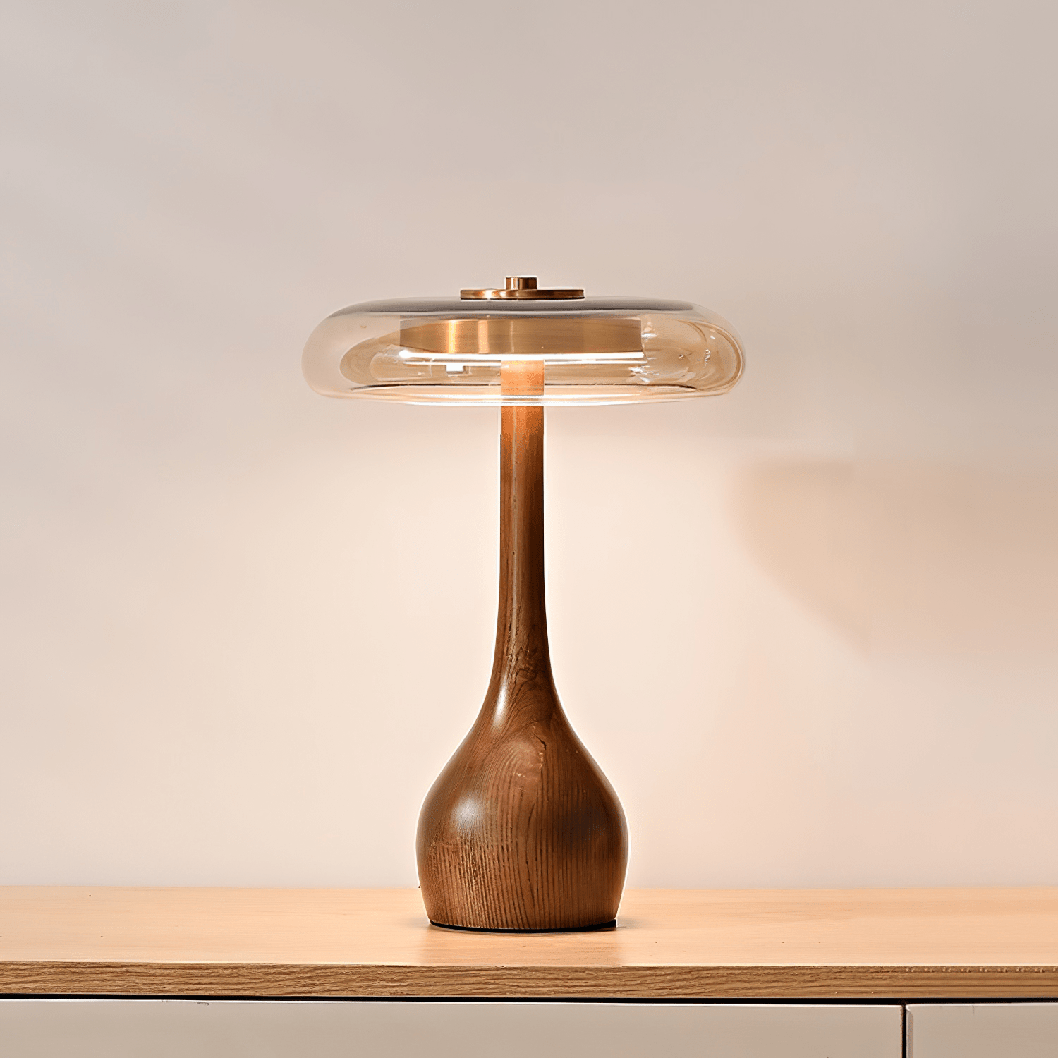 Amber glass table lamp casting a warm golden glow on a surface