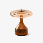 Curved walnut wood table lamp with softly lit amber shade