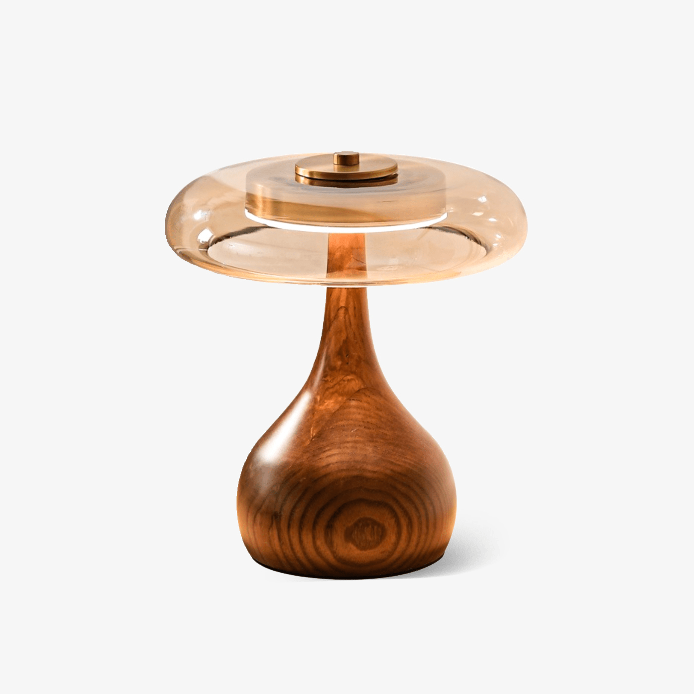 Curved walnut wood table lamp with softly lit amber shade