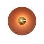 A deep bronze-brown Clérachic wall light glows warm on white, its antique copper centre bright at its core.