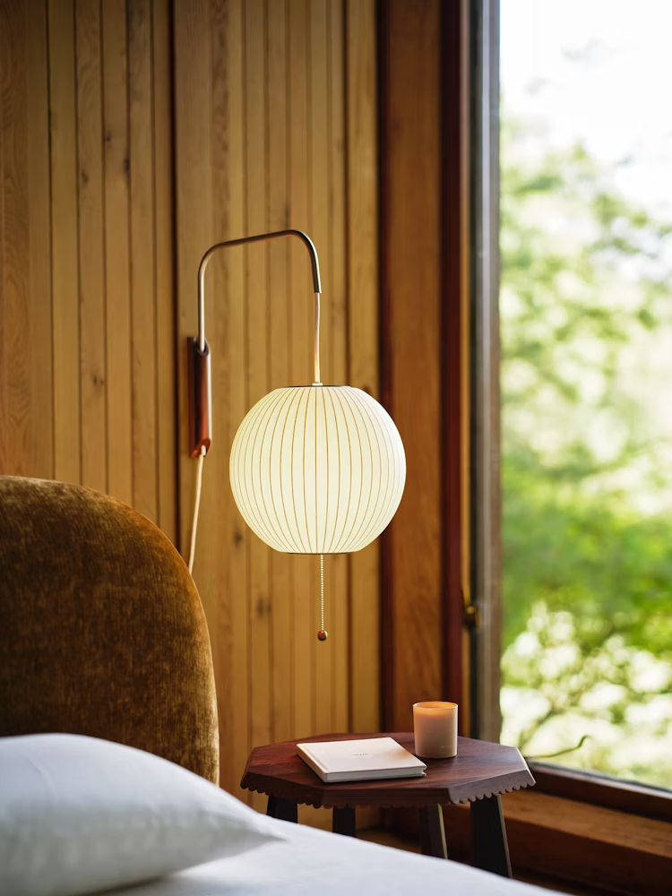 White ball wall sconce detail of swivel hinge and mounting plate