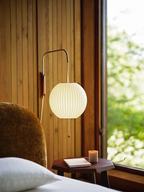 White ball wall sconce detail of swivel hinge and mounting plate