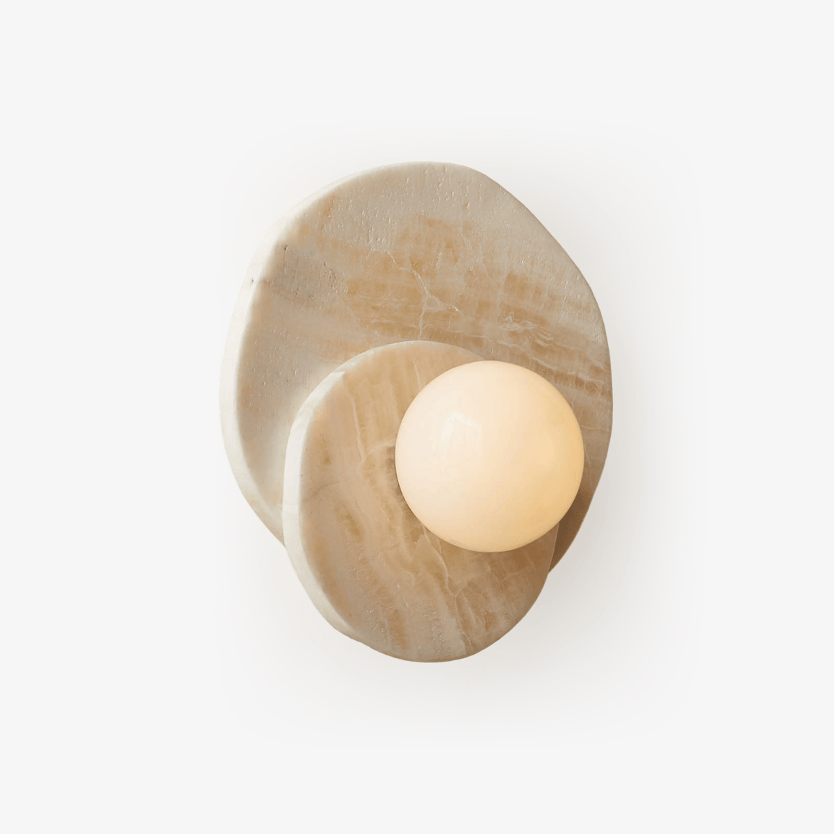 A pale alabaster Clérachic wall light with two overlapping stone discs framing a glowing glass globe, shot alone on white.