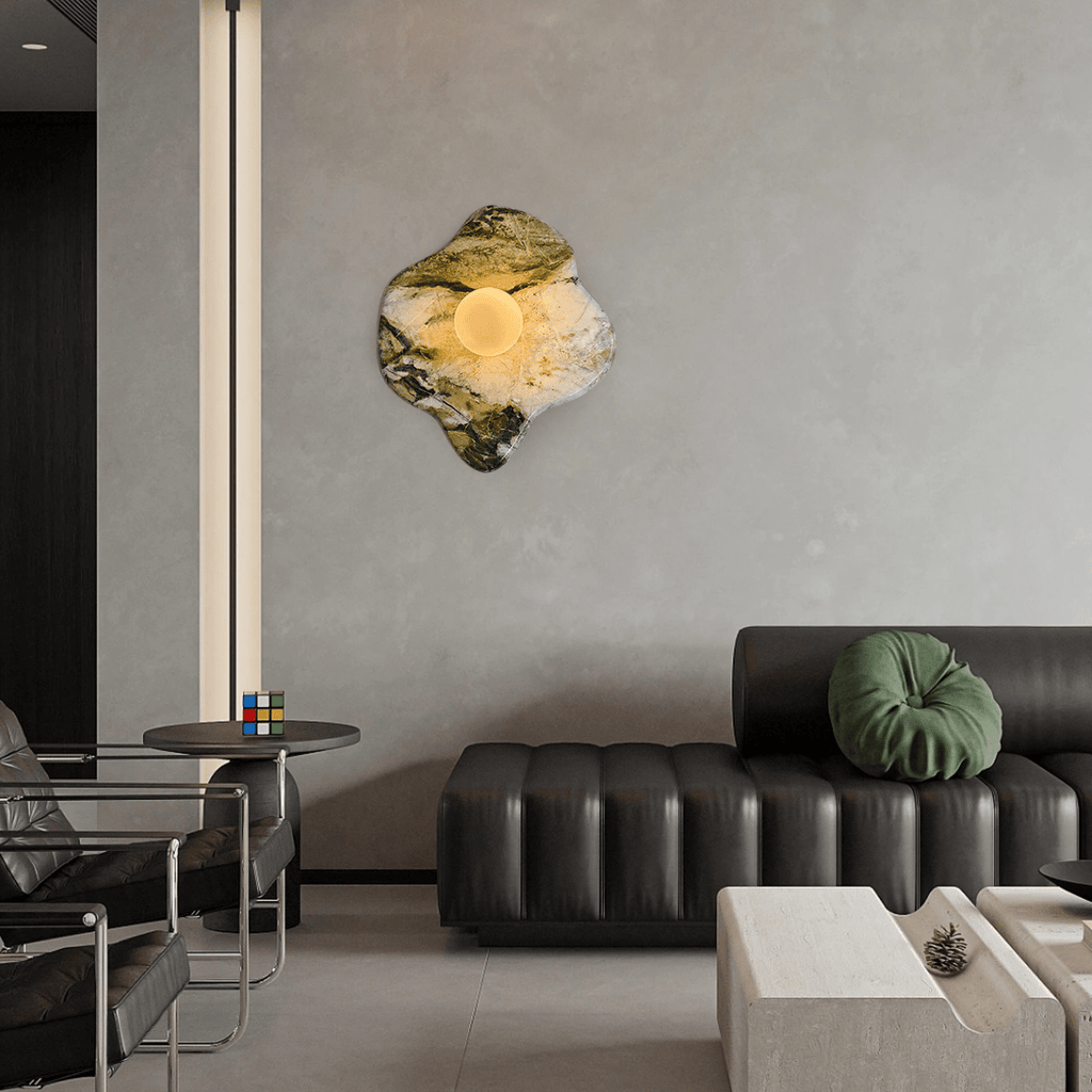 In a grey-toned living room with a dark leather sofa and slim floor lamp, this Clérachic wall light sits high on the wall.