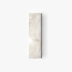 Sculptural alabaster sconce with curved stone form and soft glow