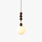 Strung wood bead pendant light detail with glass shade