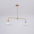 On a plain grey background, this Clérachic pendant stands unlit, its brass frame fully visible.