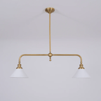 Set on grey, this Clérachic pendant's brass arms and white conical shades sit unlit, seen from a slight angle.