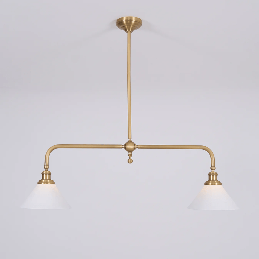 This Clérachic pendant sits unlit on a plain grey background, its brass stem centred above two matching shades.