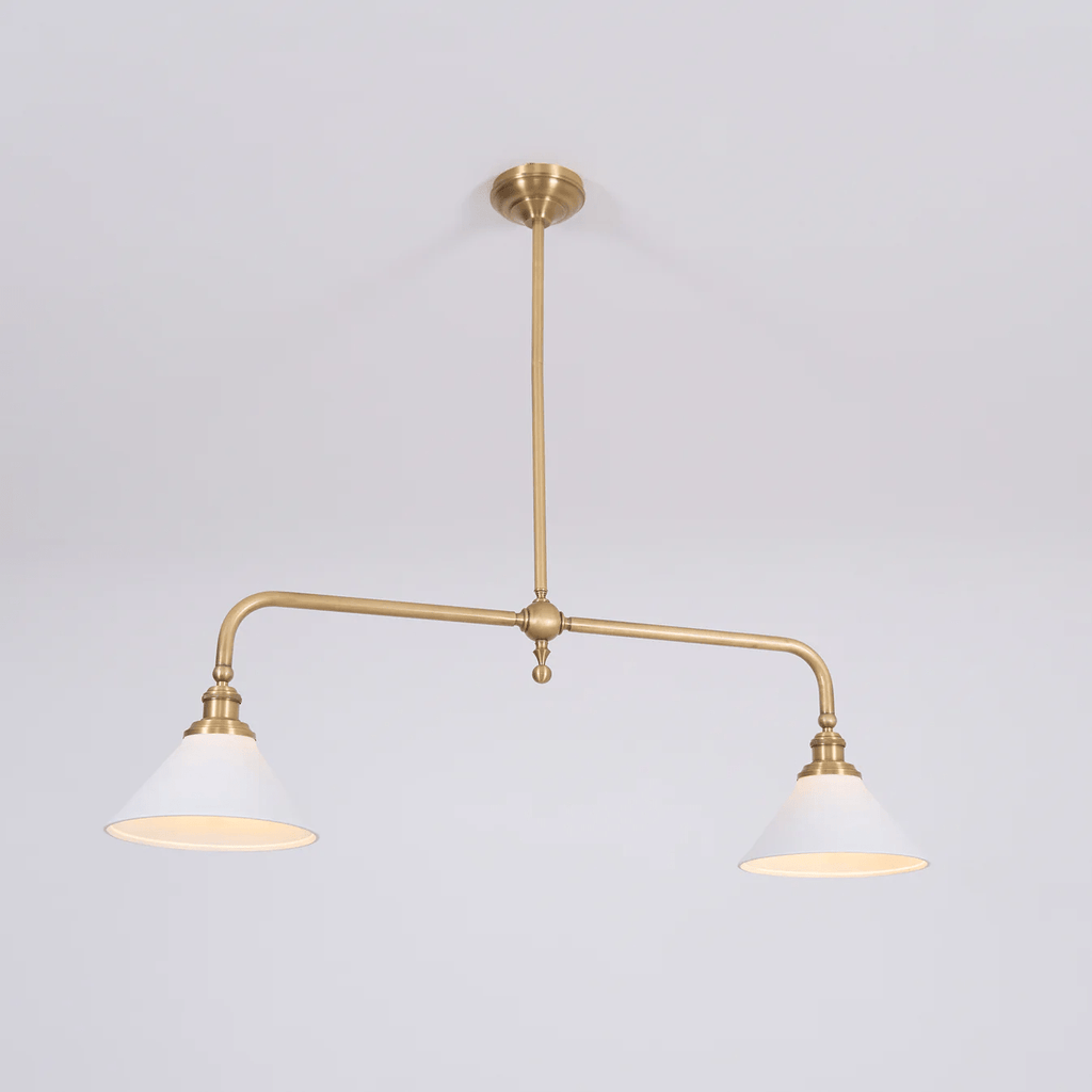 Warm light glows from both shades of this Clérachic pendant, shown on a plain grey background.