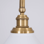 Close view of the knurled brass socket collar on this Clérachic pendant, sitting just above one white conical shade.