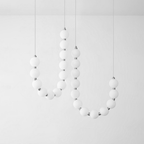 Acrylic pearl chandelier in a waterfall drop over a stairwell