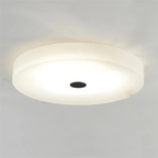 Olaean flush mount on a plain background with its black centre cap and lit alabaster shade.