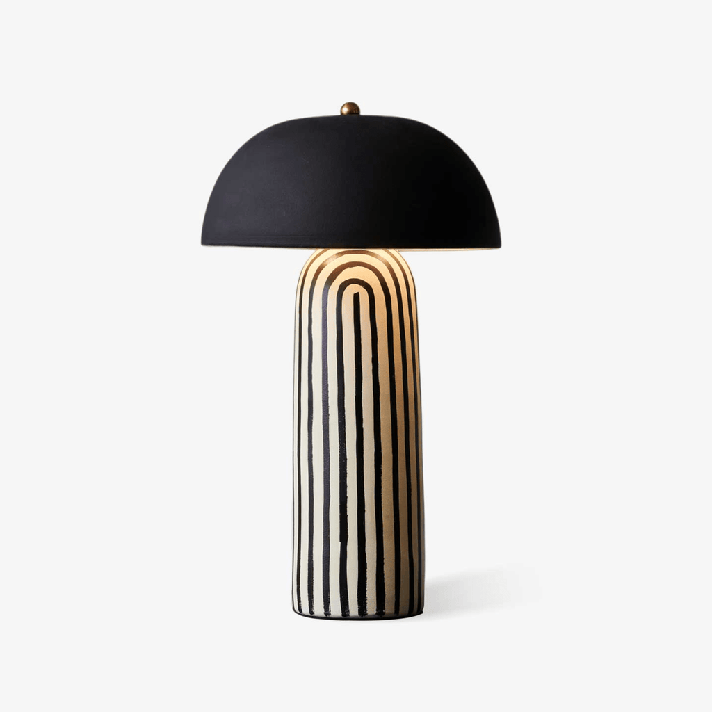 This Clérachic table lamp is photographed on a soft white backdrop, showing the black-and-white stripes of its ceramic base.
