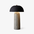 This Clérachic table lamp is photographed on a soft white backdrop, showing the black-and-white stripes of its ceramic base.