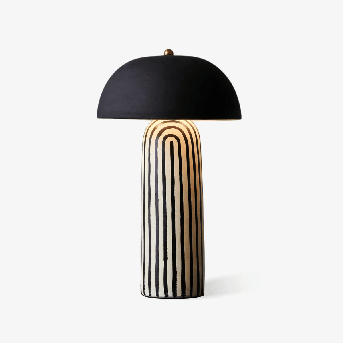 This Clérachic table lamp is photographed on a soft white backdrop, showing the black-and-white stripes of its ceramic base.