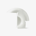 Clérachic curved white resin table lamp photographed unlit on a plain light-grey studio background, showing its crescent shape.