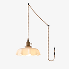 This Clérachic pendant appears in a plug-in wall diagram, its cord routed from ceiling hook to a wall plug beside the beige shade.