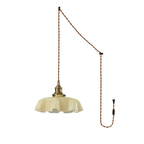 The plug-in diagram for this Clérachic pendant shows a twisted brown cord running from ceiling hook to wall plug, ending in the beige shade.