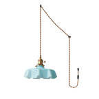 The plug-in diagram for this Clérachic pendant shows a twisted brown cord running from ceiling hook to wall plug, ending in the blue shade.