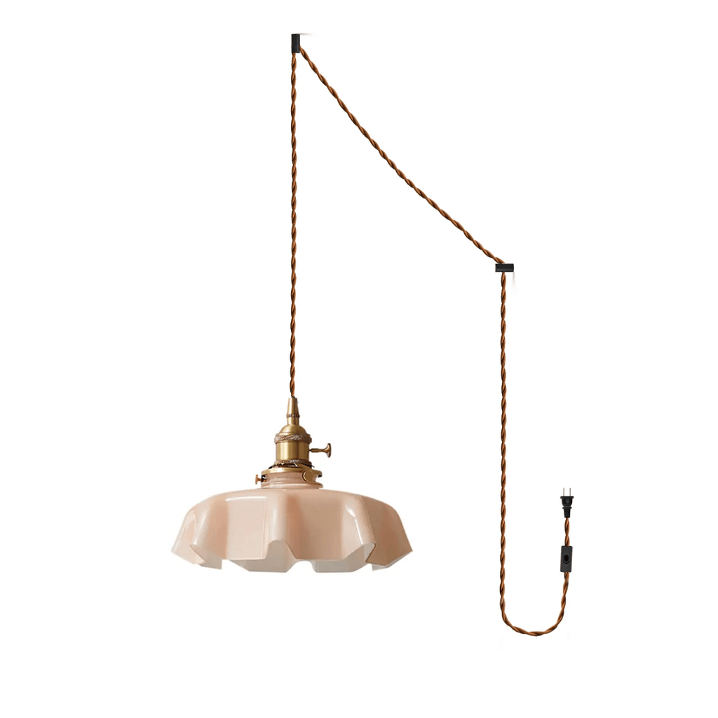 The plug-in diagram for this Clérachic pendant shows a twisted brown cord running from ceiling hook to wall plug, ending in the blush pink shade.