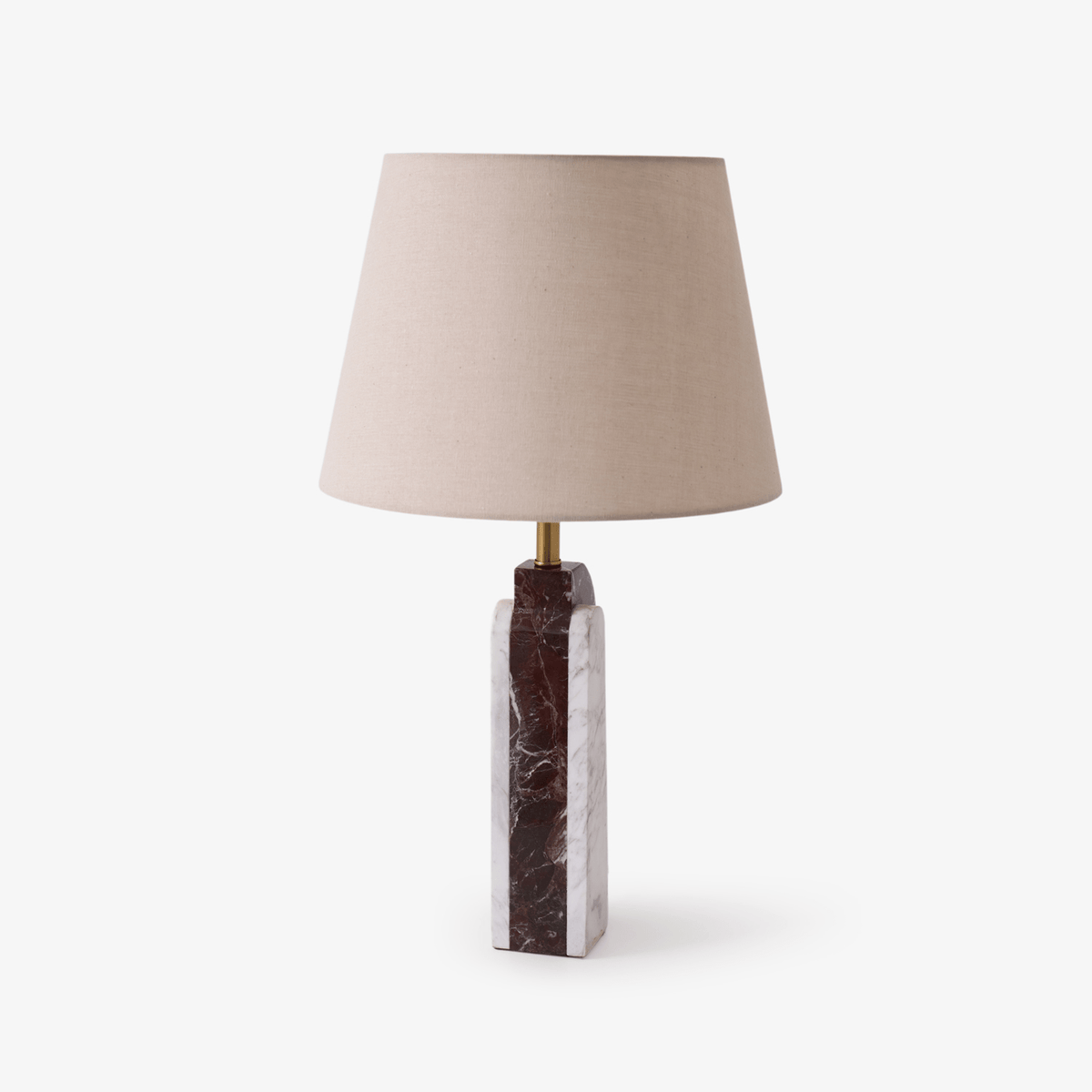 A tapered cream fabric shade on a square-cut burgundy marble column, the Clérachic table lamp shown against plain white.