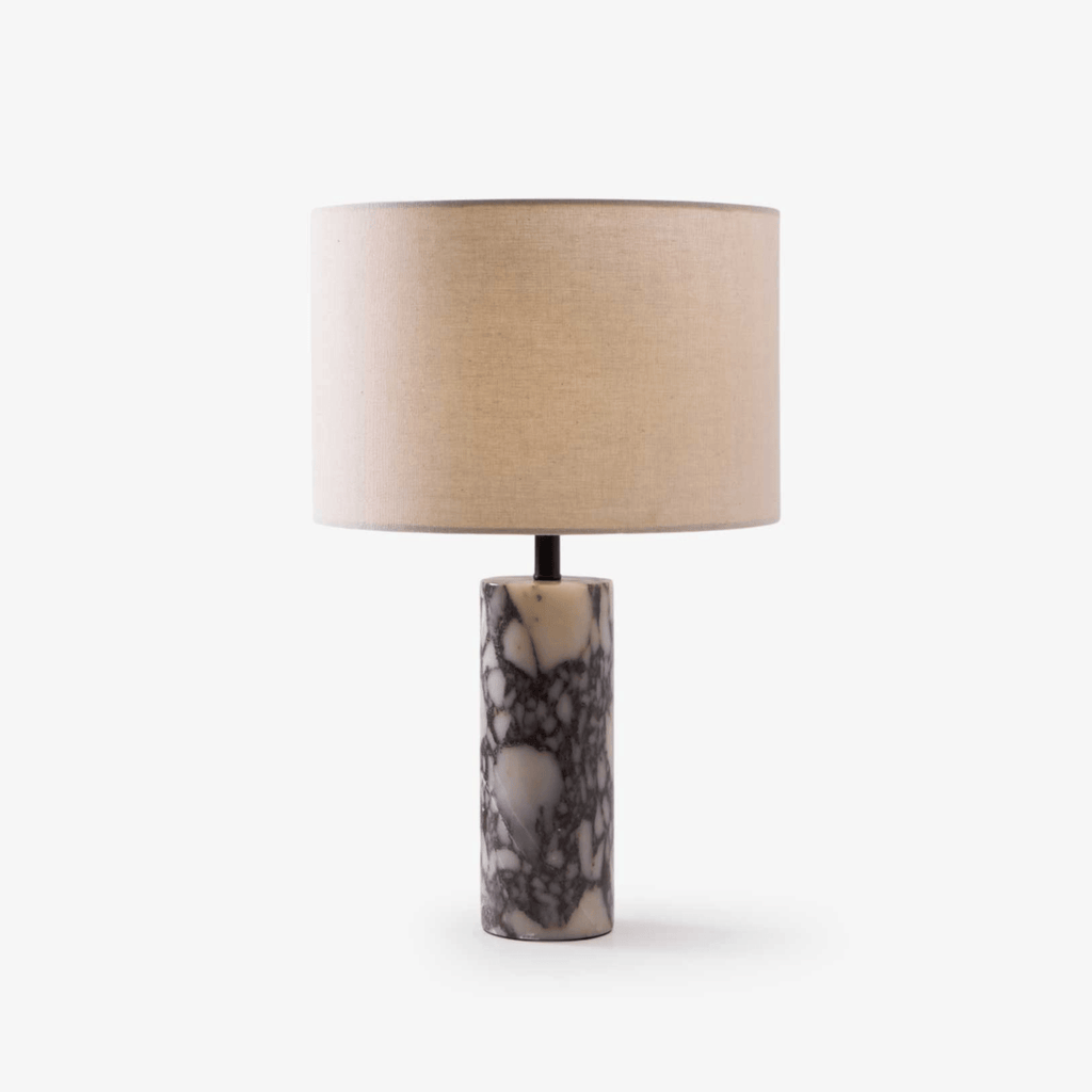 Clérachic marble table lamp with a grey-veined column base and wide beige linen shade, on a plain grey studio background.