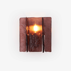 Gold brass wall sconce casting geometric light patterns across a wall