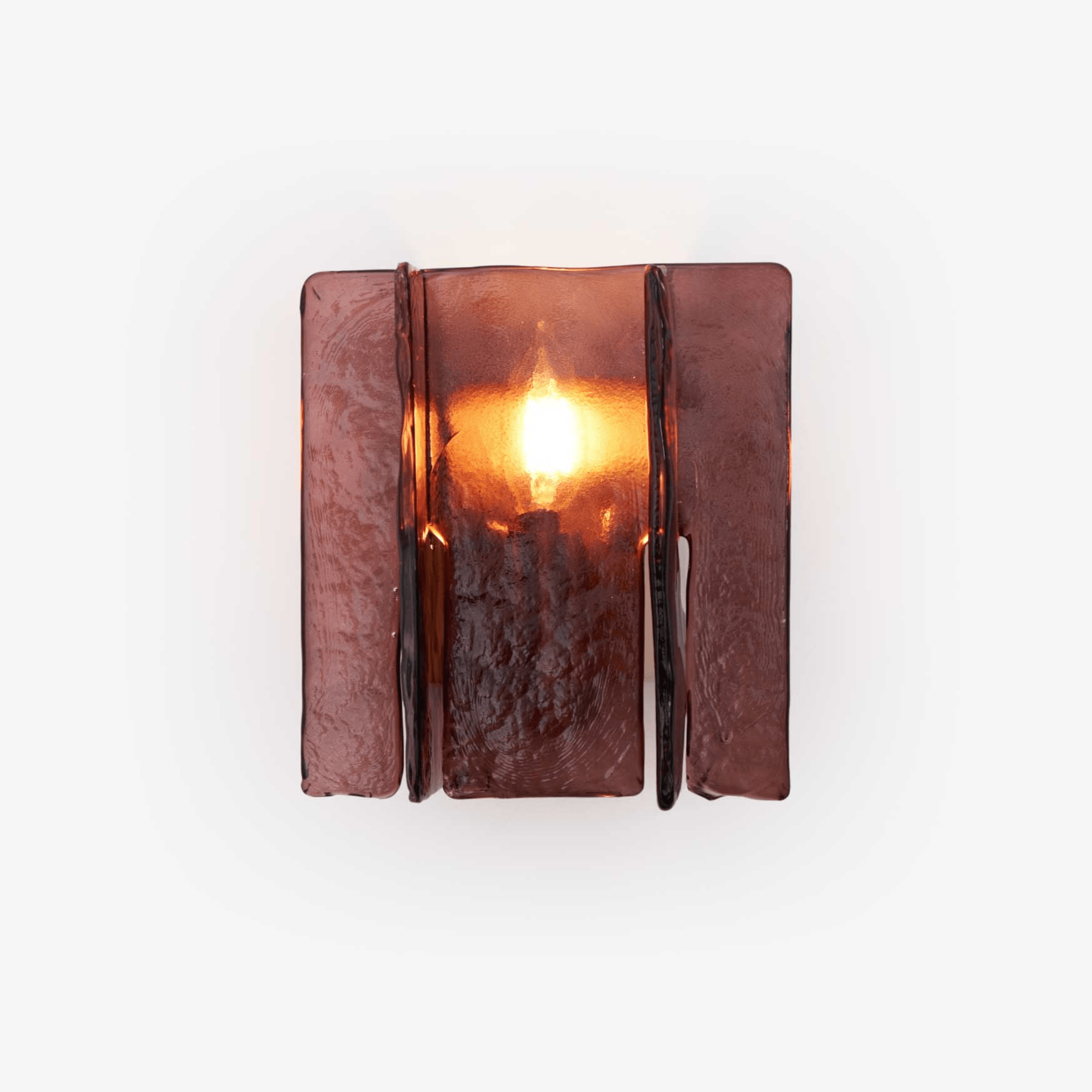 Gold brass wall sconce casting geometric light patterns across a wall