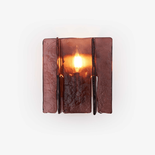 Gold brass wall sconce casting geometric light patterns across a wall