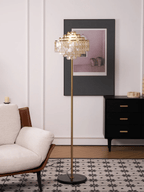 A black-and-white tiled floor sits beneath this Clérachic floor lamp, next to a dark dresser with brass pulls.
