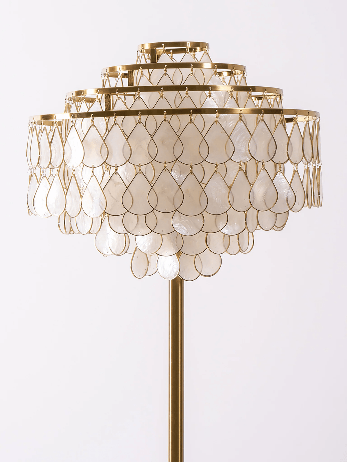 Close view of the layered mother-of-pearl petals forming this Clérachic floor lamp's tiered shade.
