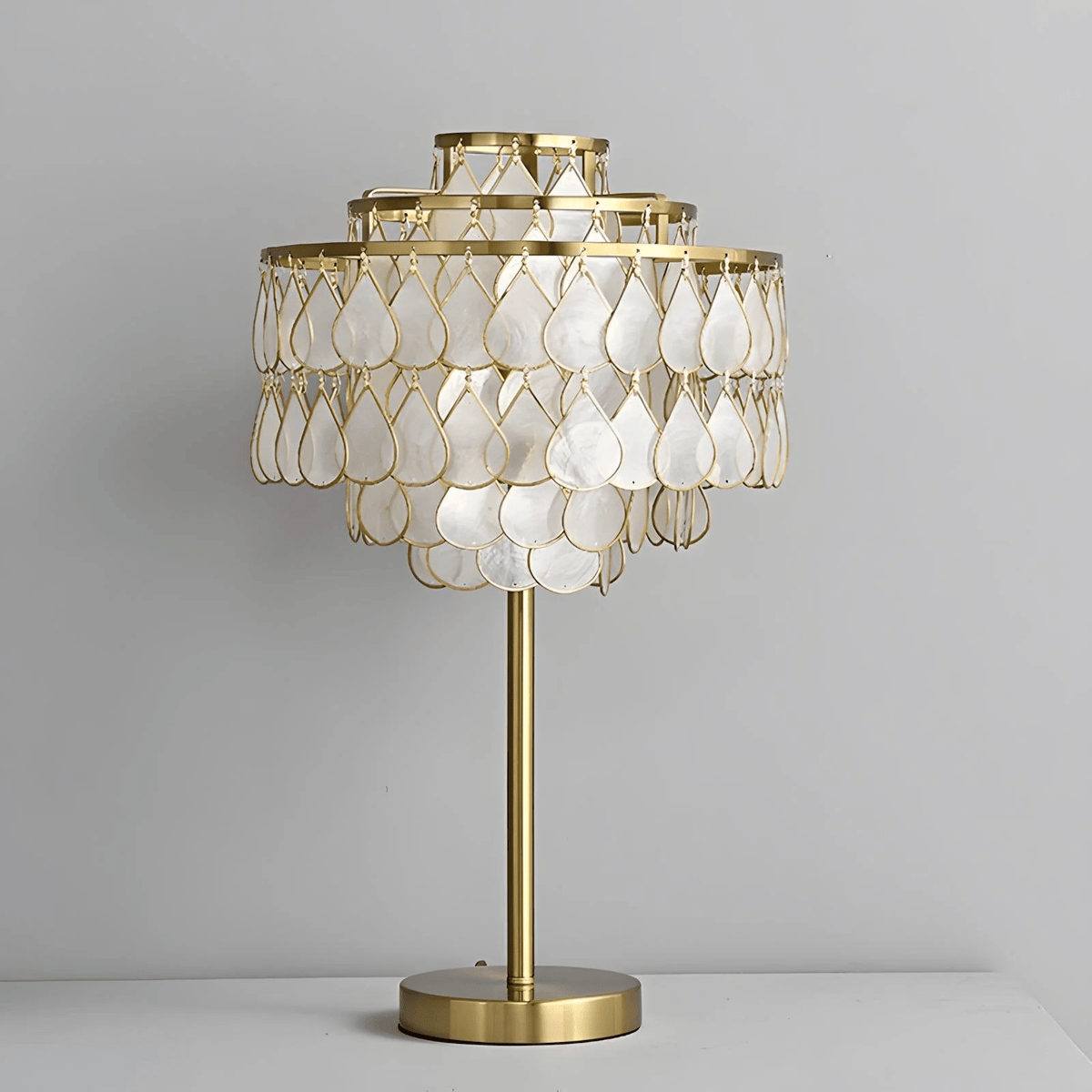 Clérachic table lamp with a brass base, an isolated product shot softly lit against a plain background.