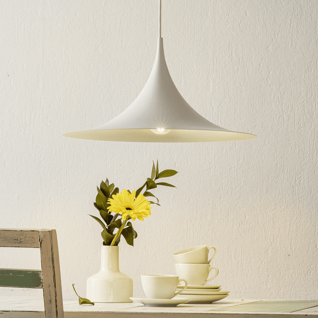 Yellow arch pendant light against a plain wall
