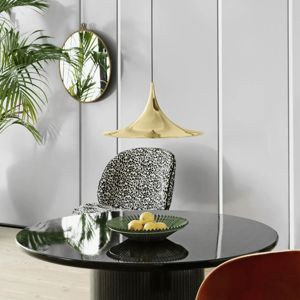 Two arch pendant lights paired above a long table