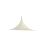 White arch pendant light against a pale ceiling